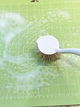 how to clean cricut cutting mats - soft brush in circular motion