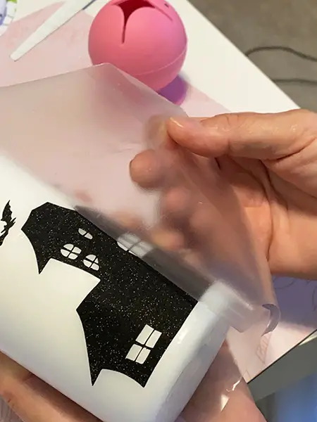 apply adhesive vinyl on wax candles - remove transfer tape